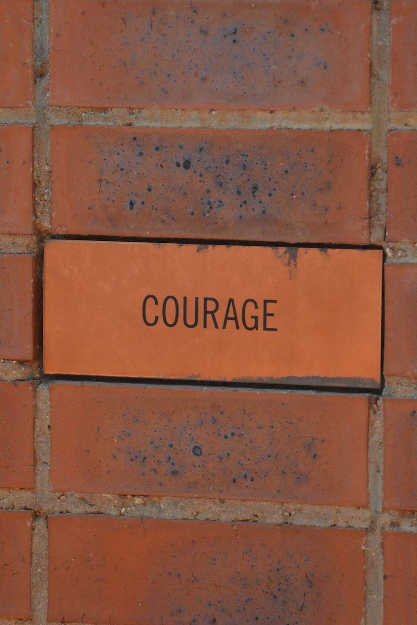 brown brick wall with no smoking sign